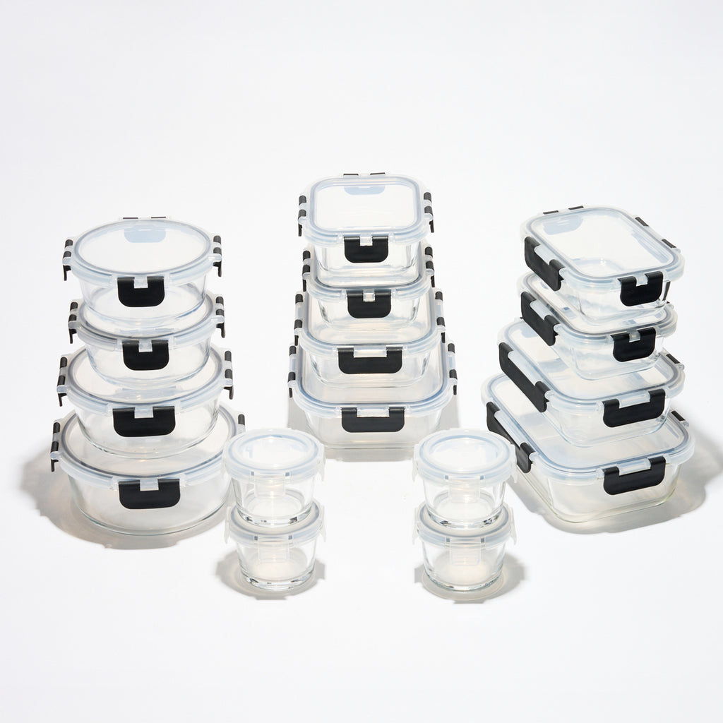 The full Storinity 32-Piece Glass Storage Container set, empty, grouped by round, square and rectangular shapes