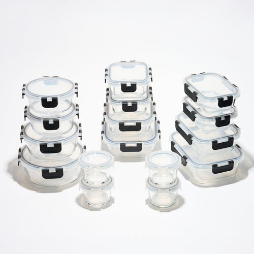 The full Storinity 32-Piece Glass Storage Container set, empty, grouped by round, square and rectangular shapes