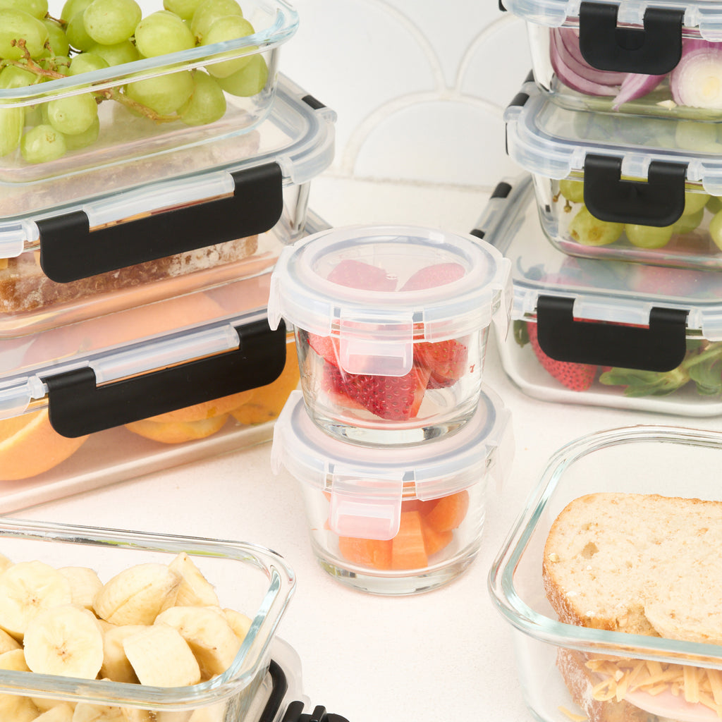 Close-up of several Storinity glass storage containers filled with fruit and a sandwich on a kitchen counter