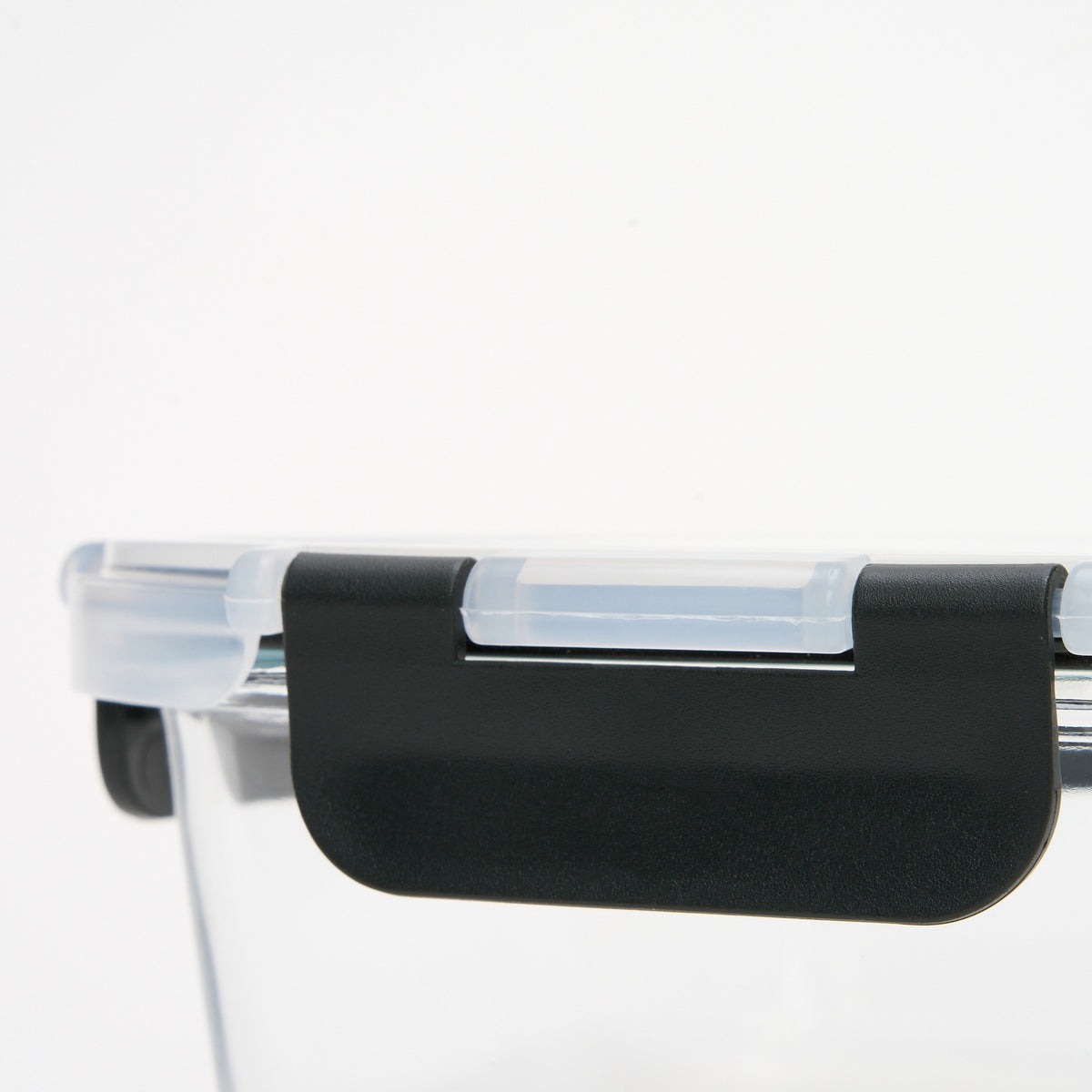 Close-up of the black locking clip mechanism on a Storinity glass storage container lid