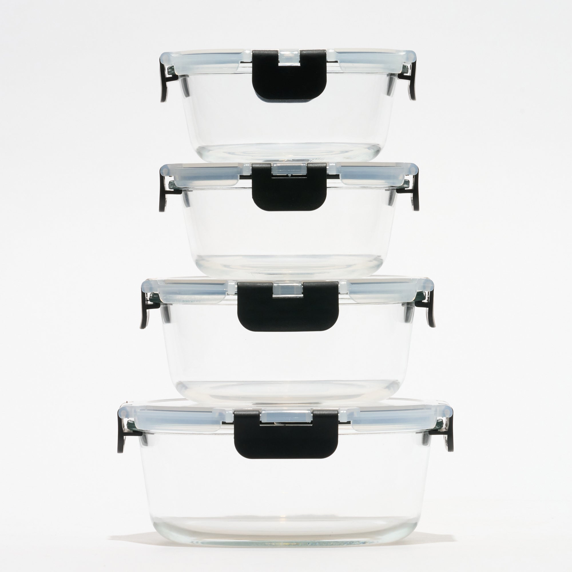 Stack of four empty round Storinity glass storage containers