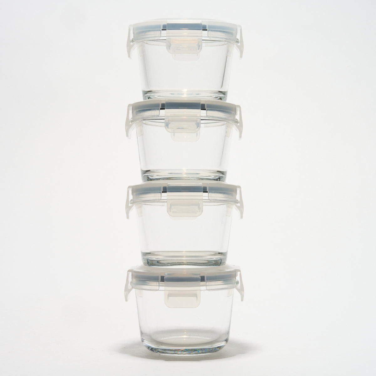 Stack of four empty small round Storinity glass storage containers