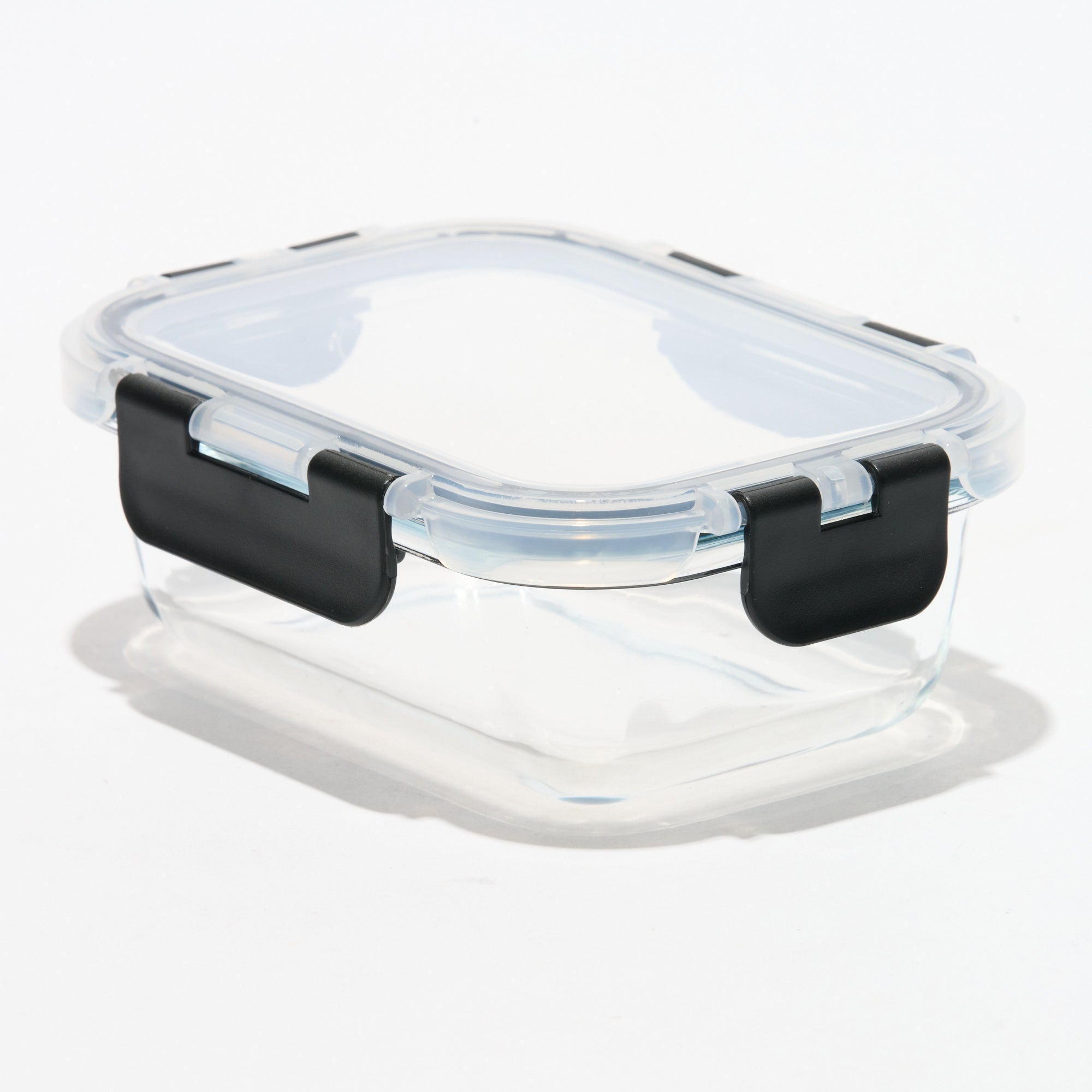 Empty rectangular Storinity glass storage container with locking lid closed, angled view