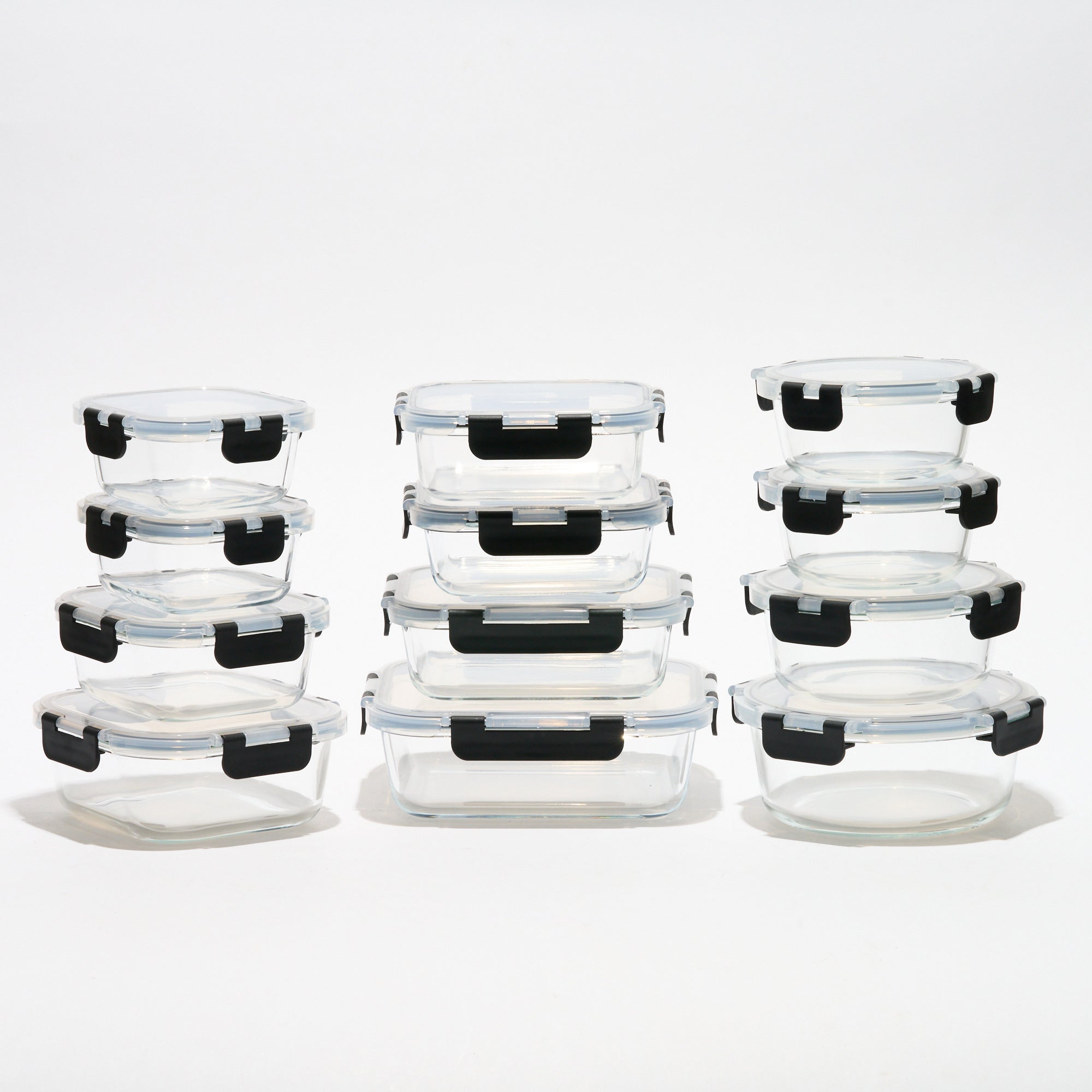 The full Storinity 24-Piece Air Tight Glass Storage Container set, empty, grouped by square, rectangular and round shapes
