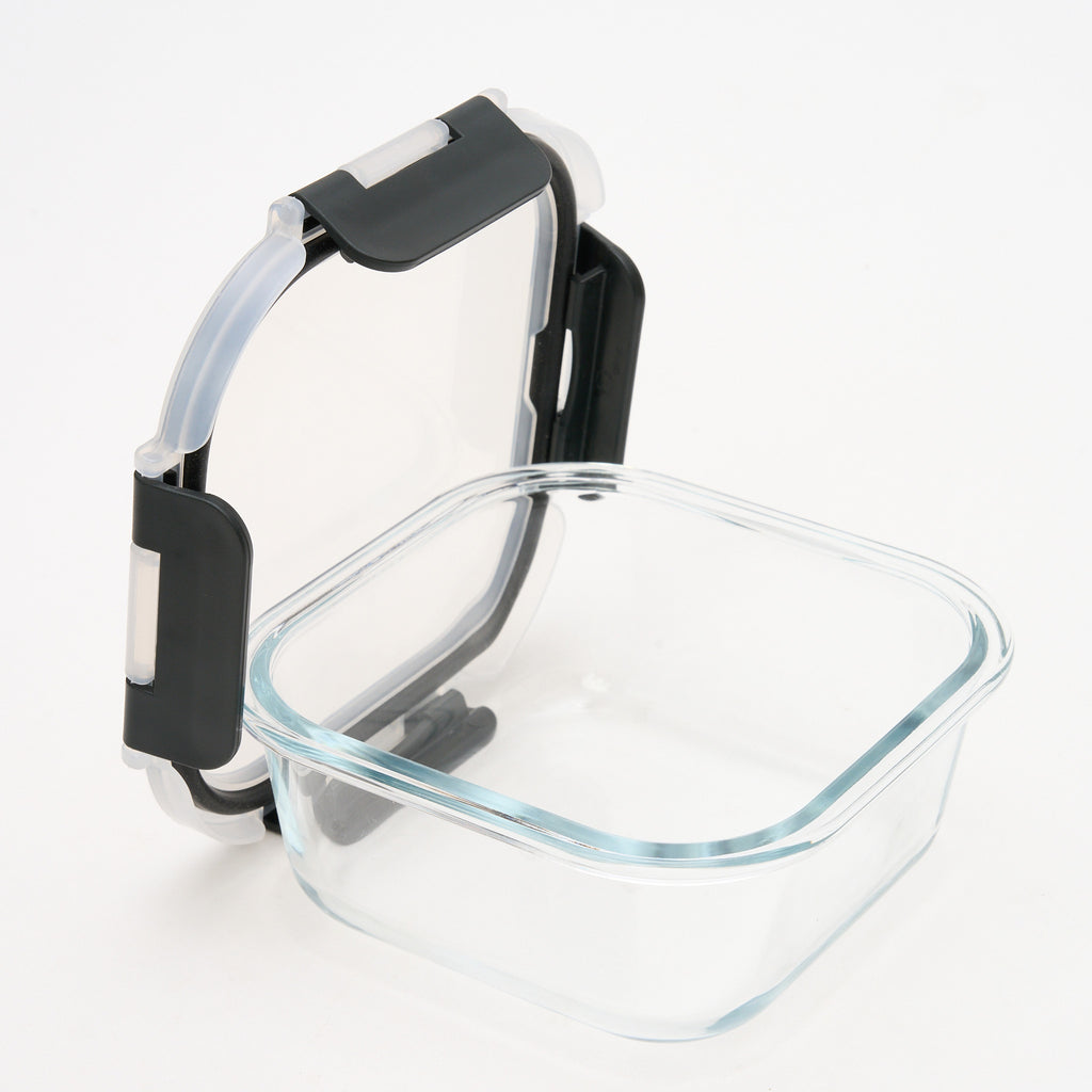 Empty square Storinity glass container with the lid propped open, showing the airtight silicone seal