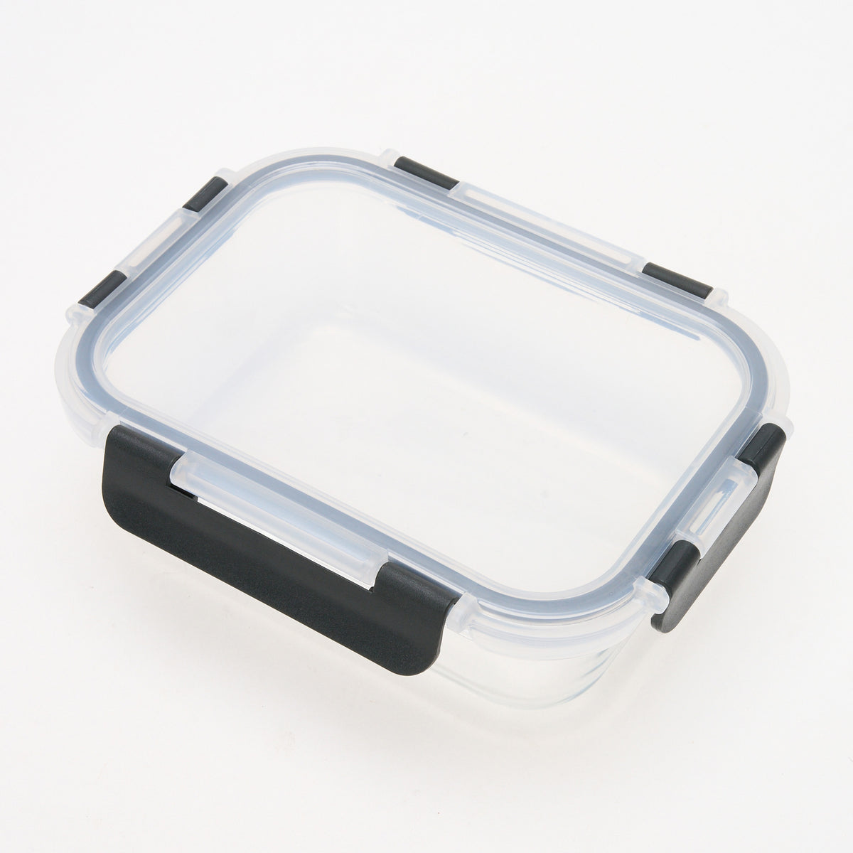 Empty rectangular Storinity glass storage container with locking lid, viewed from above at an angle