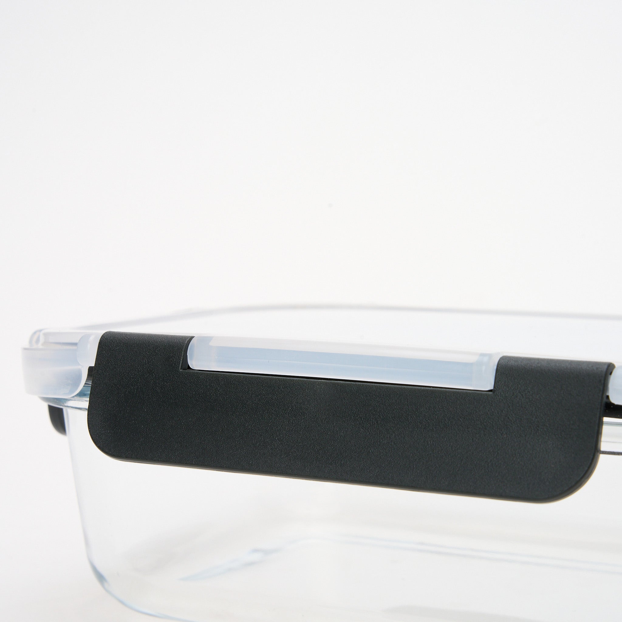 Close-up of the black locking clip mechanism on a Storinity glass storage container lid