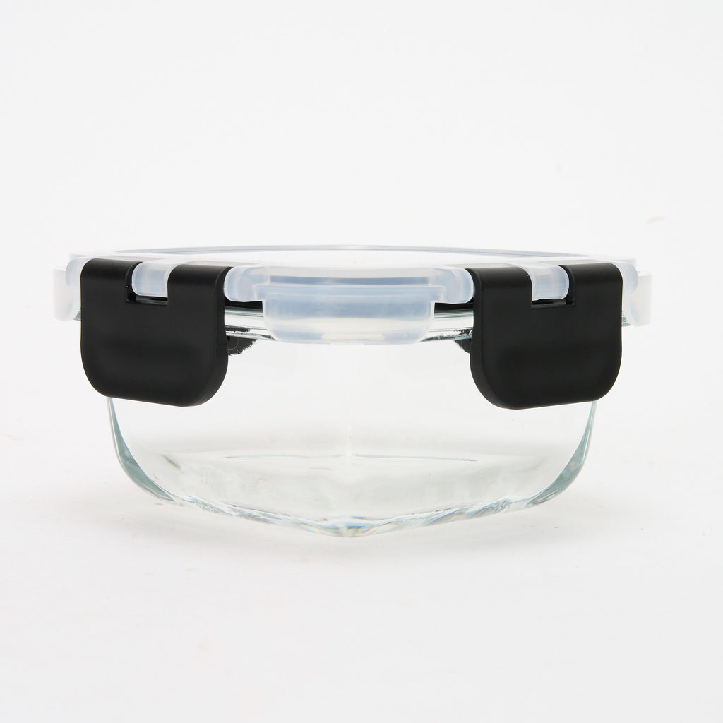 Empty round Storinity glass container with black locking lid closed, front view