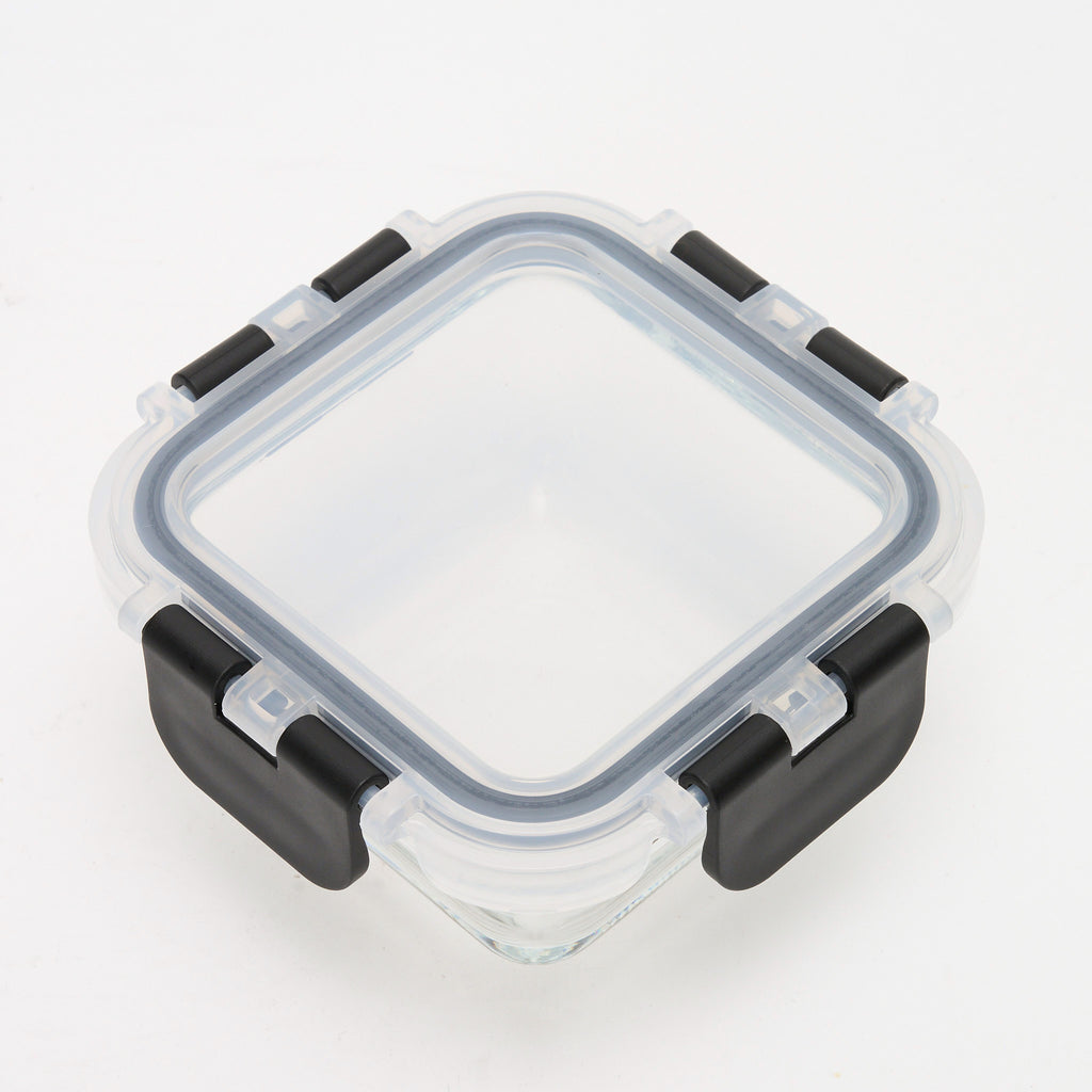 Empty square Storinity glass container with black locking lid closed, angled overhead view