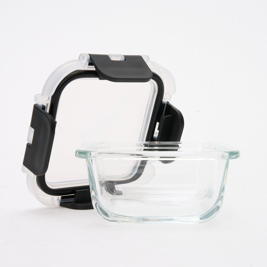 Empty square Storinity glass container with the lid propped open, showing the seal