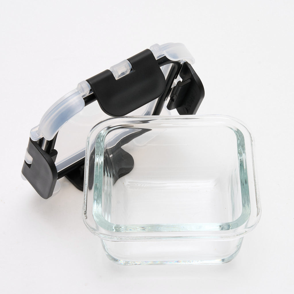Empty square Storinity glass container with the lid propped open at an angle