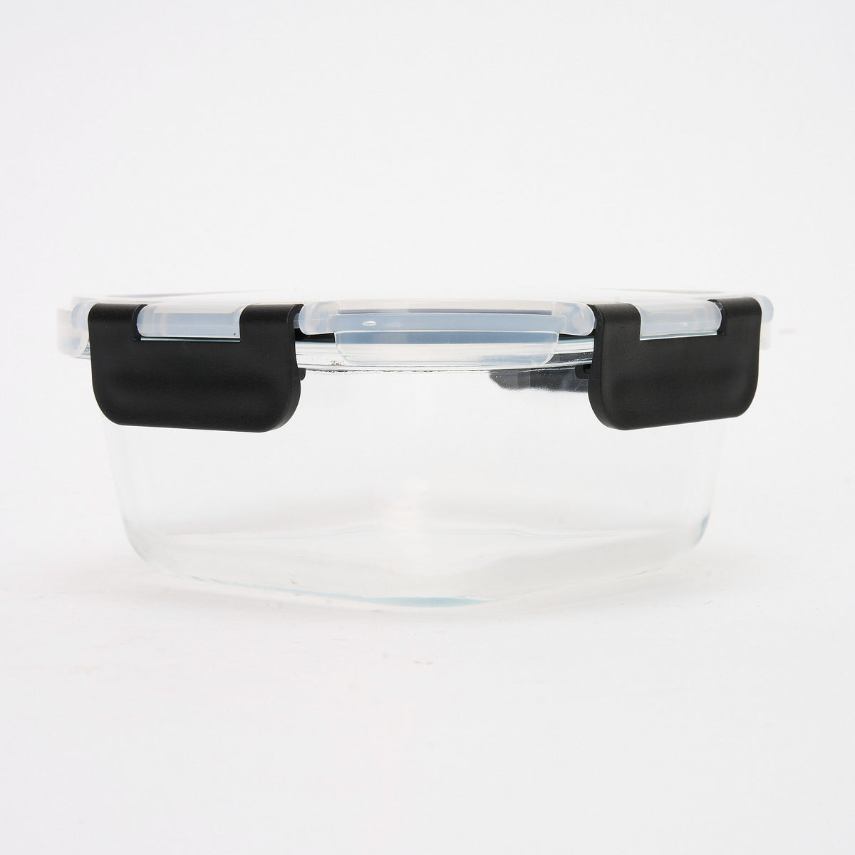 Empty round Storinity glass container with black locking lid closed, front view