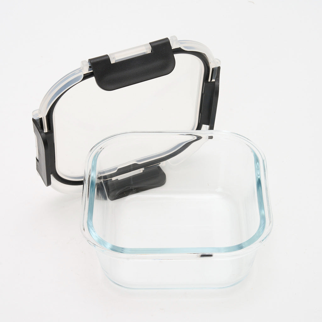 Empty square Storinity glass container with the lid propped open beside it