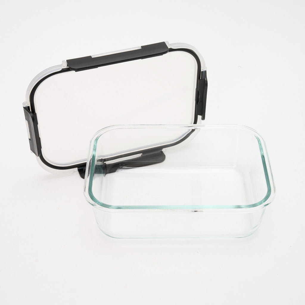Empty rectangular Storinity glass container with the lid propped open beside it