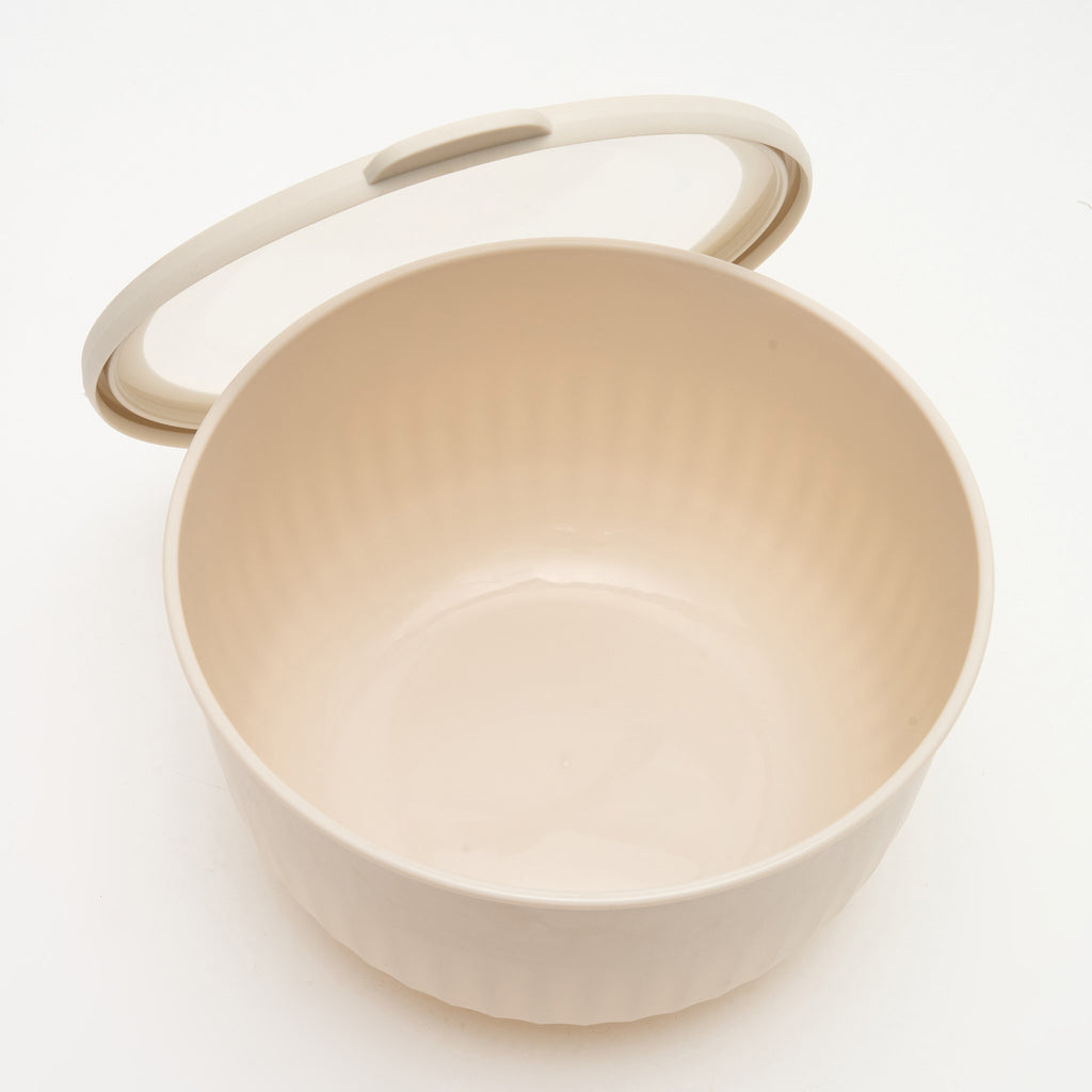 A medium-large Storinity nesting bowl, empty, with the lid propped open, overhead angle