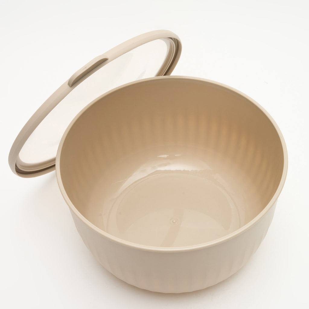 The largest Storinity nesting bowl, empty, with the lid propped open, overhead view