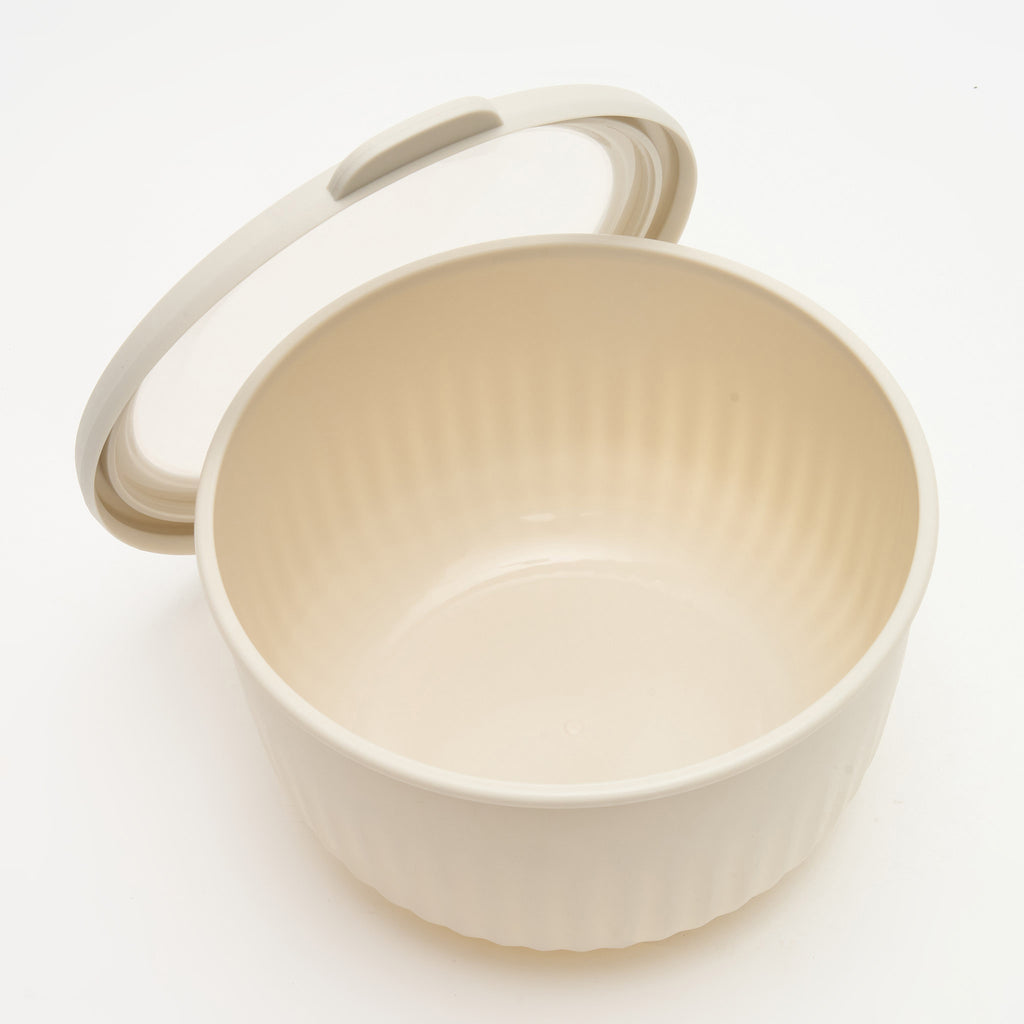 The second-largest Storinity nesting bowl, empty, with the lid propped open, overhead view