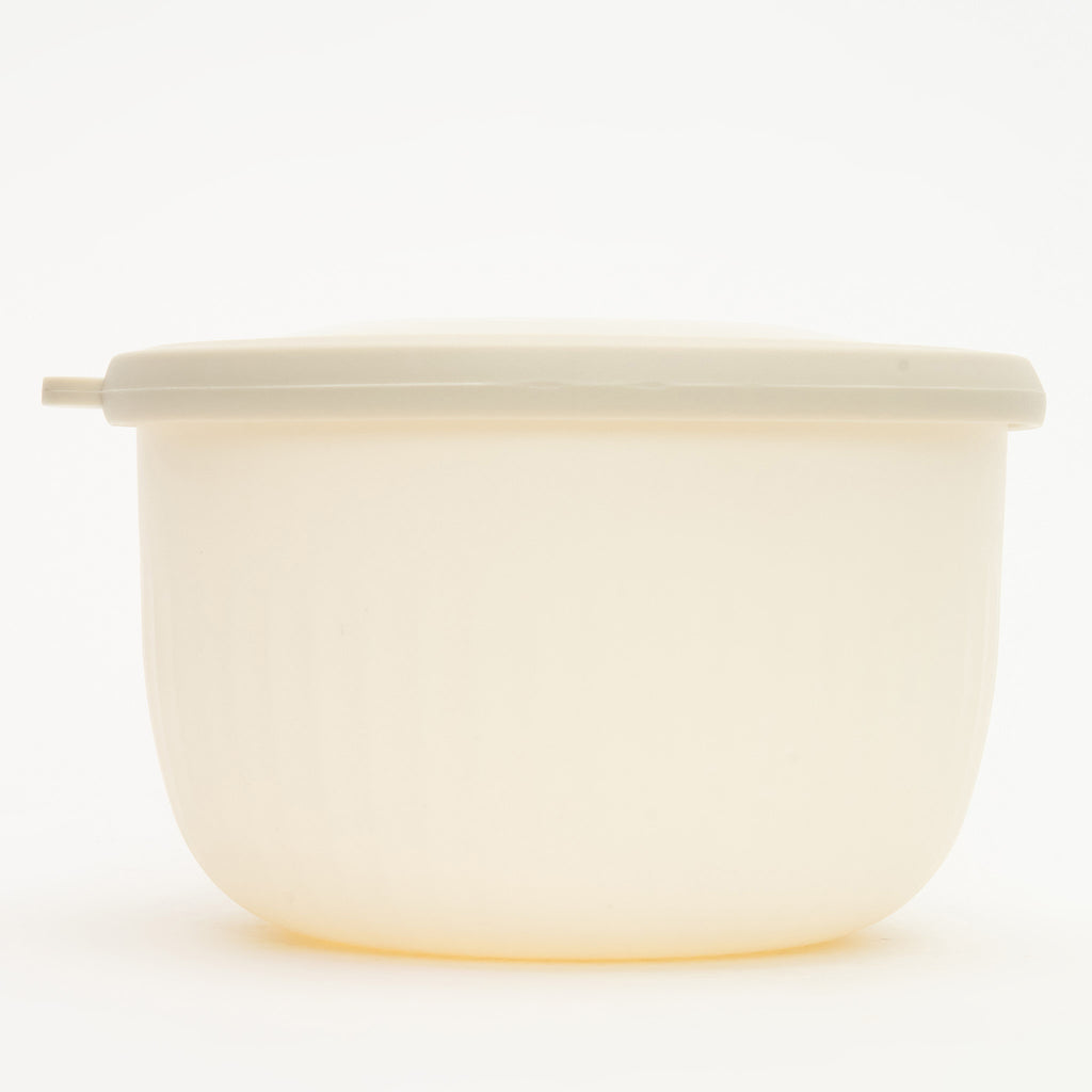 A medium Storinity nesting bowl, empty, with its lid on, white, front view