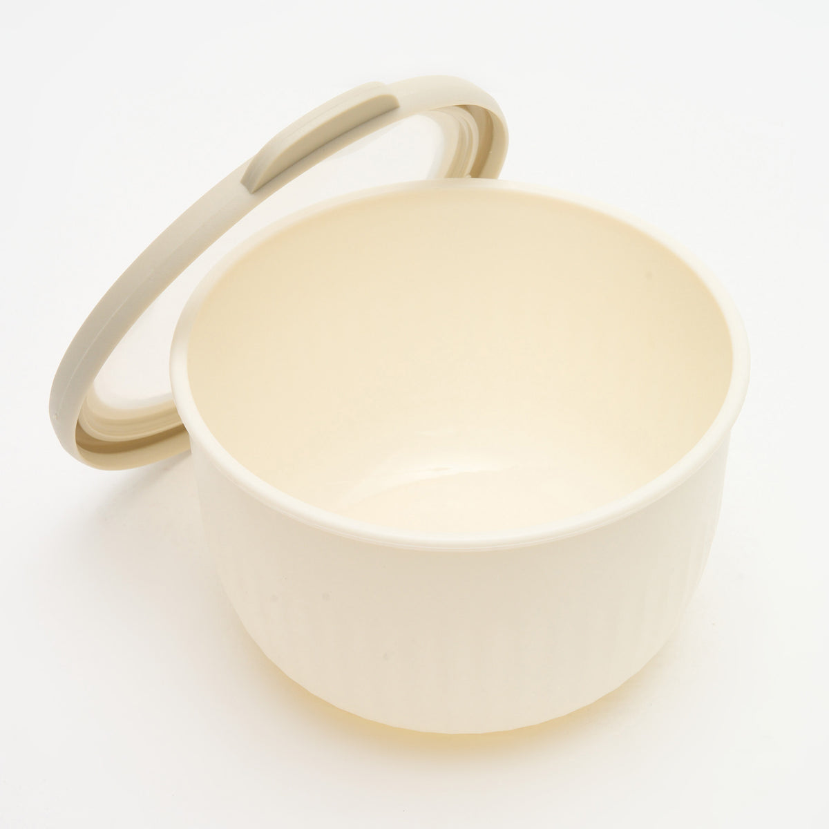 A medium Storinity nesting bowl, empty, with the lid propped open, overhead angle