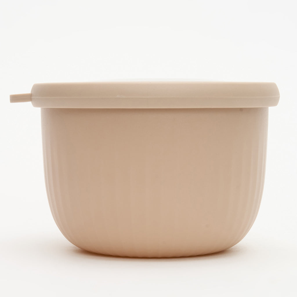 A small taupe Storinity nesting bowl, empty, with its lid on, front view