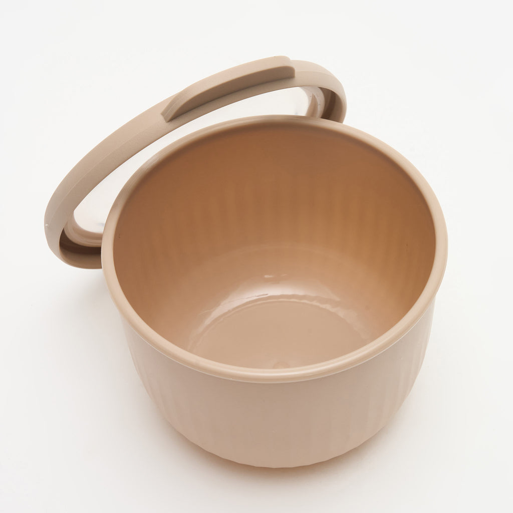 A taupe Storinity nesting bowl, empty, with the lid propped open, overhead view