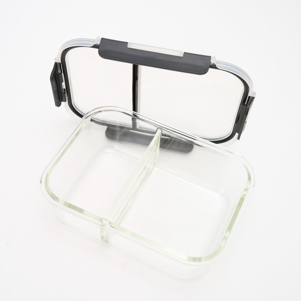 Empty Storinity divided glass container with the lid propped open, showing the centre divider