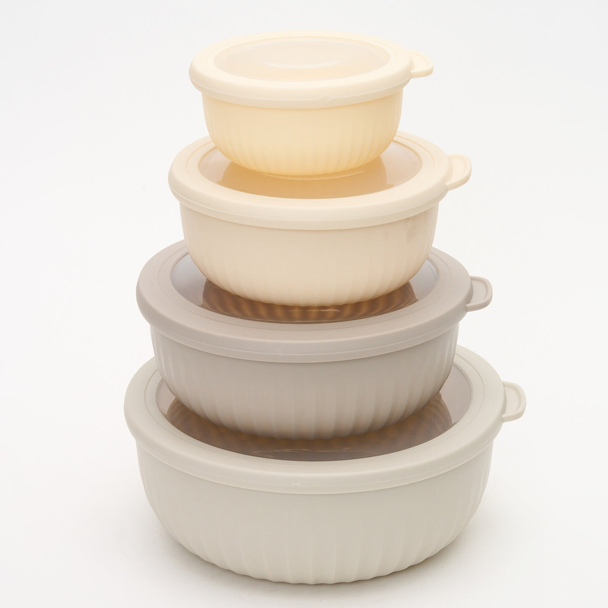 The four Storinity airtight nesting bowls stacked inside each other with their lids on, alternating cream and taupe