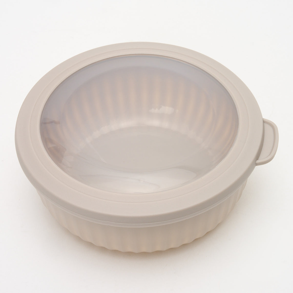 Empty taupe Storinity nesting bowl with lid closed, angled view showing the ribbed texture