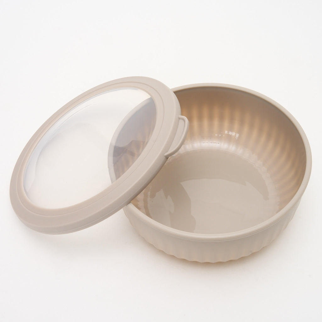 Empty taupe Storinity nesting bowl with the lid removed and placed beside it, showing the ribbed interior