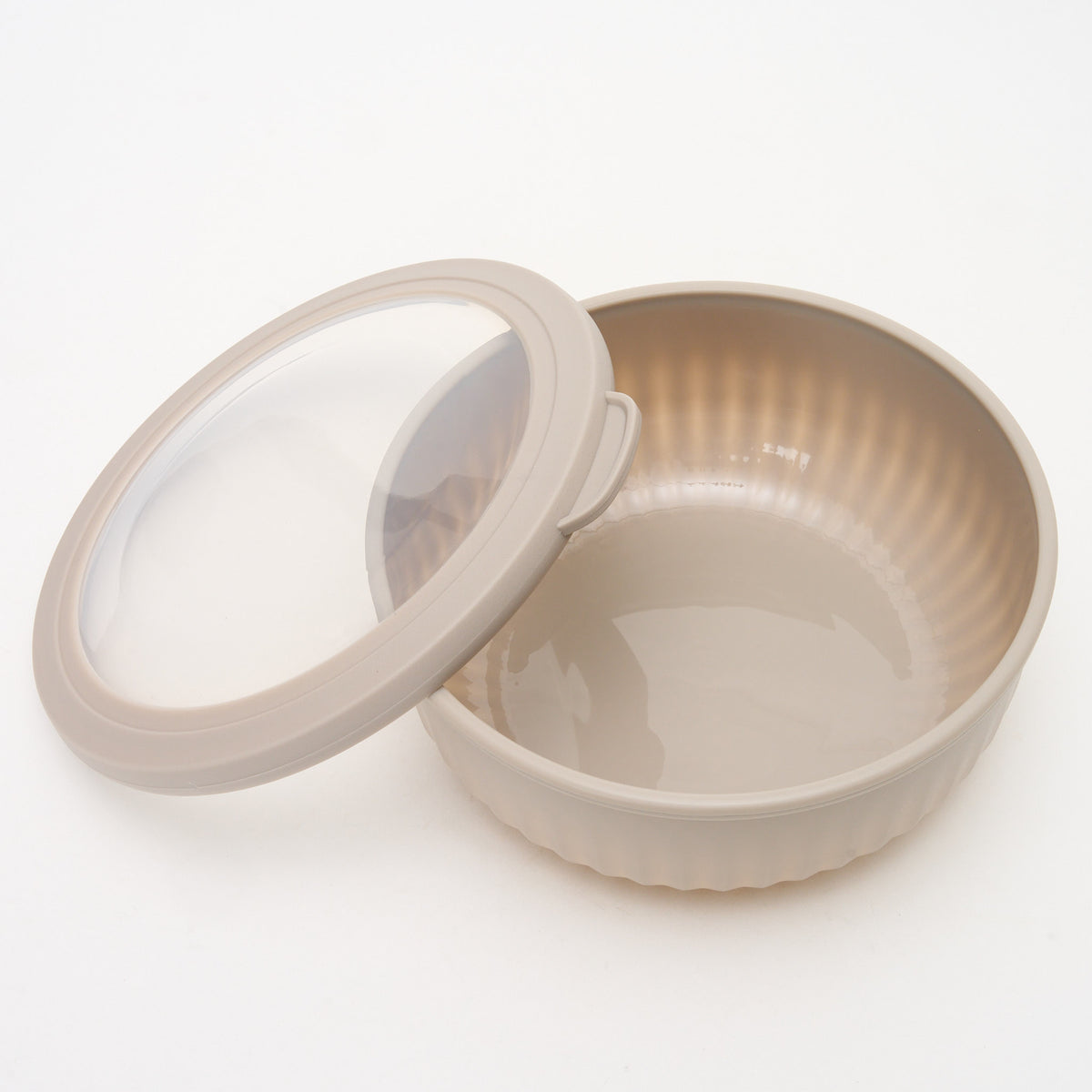 Empty taupe Storinity nesting bowl with the lid removed and placed beside it, showing the ribbed interior