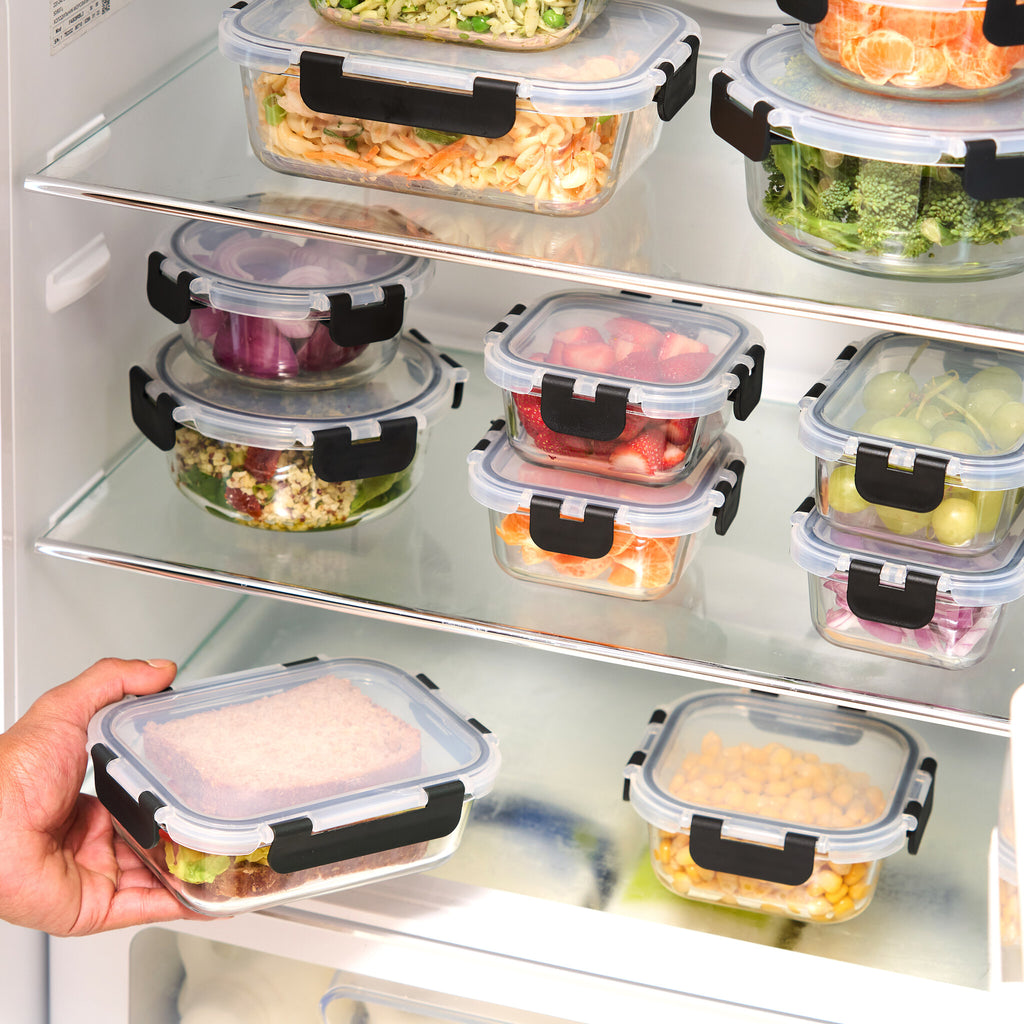 Glass storage containers stacked on fridge shelves saving space