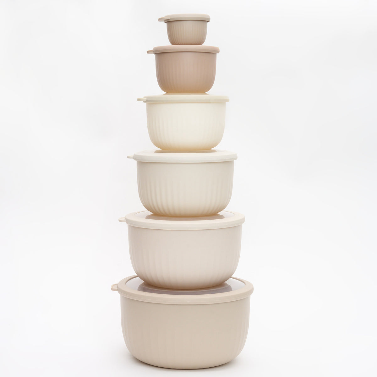 The full Storinity 12-Piece Airtight Nesting Bowl set stacked together, empty, in cream and taupe