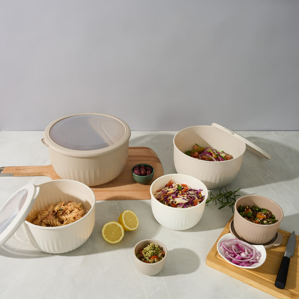 Storinity 12-Piece Airtight Nesting Bowls filled with salads, olives and citrus on a styled kitchen counter