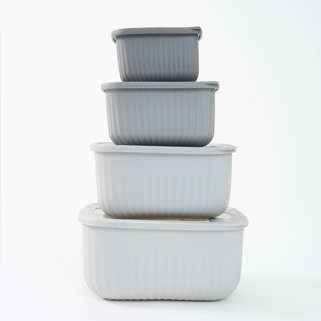 The four grey Storinity rectangular nesting bowls stacked inside each other with their lids on